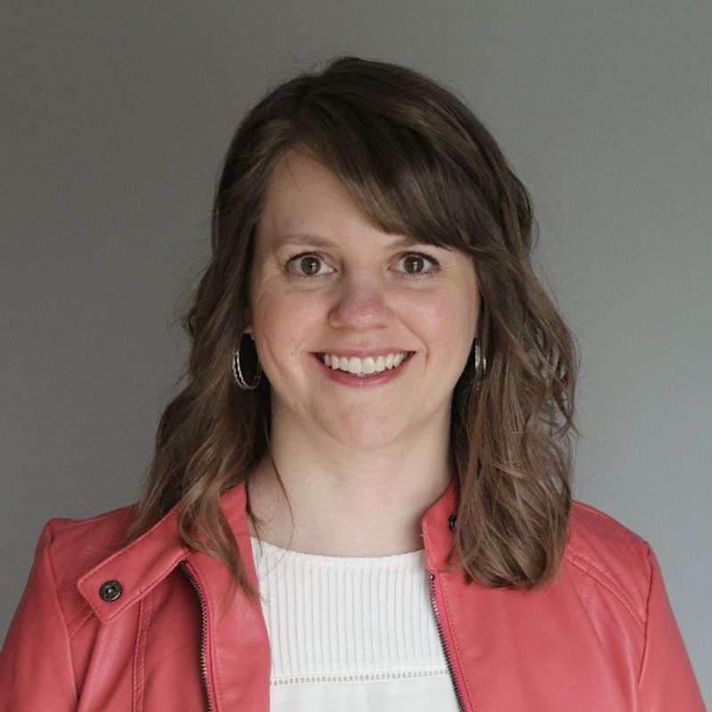 Jody Skogen wearing a coral jacket against a neutral background